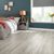 Luxury gray vinyl flooring in a cosy room with dark green walls