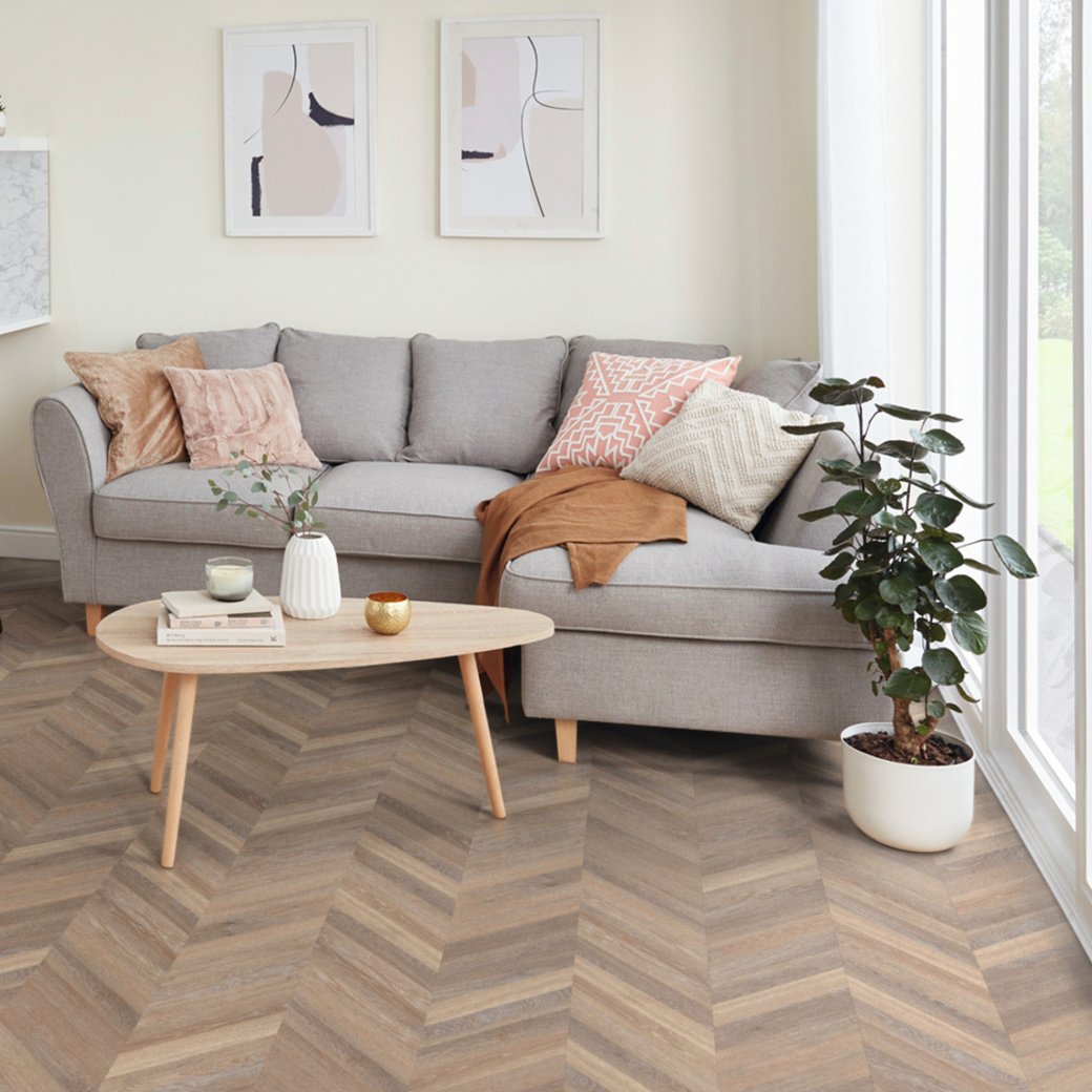 Karndean rose washed oak wood flooring laid in chevron in a living room