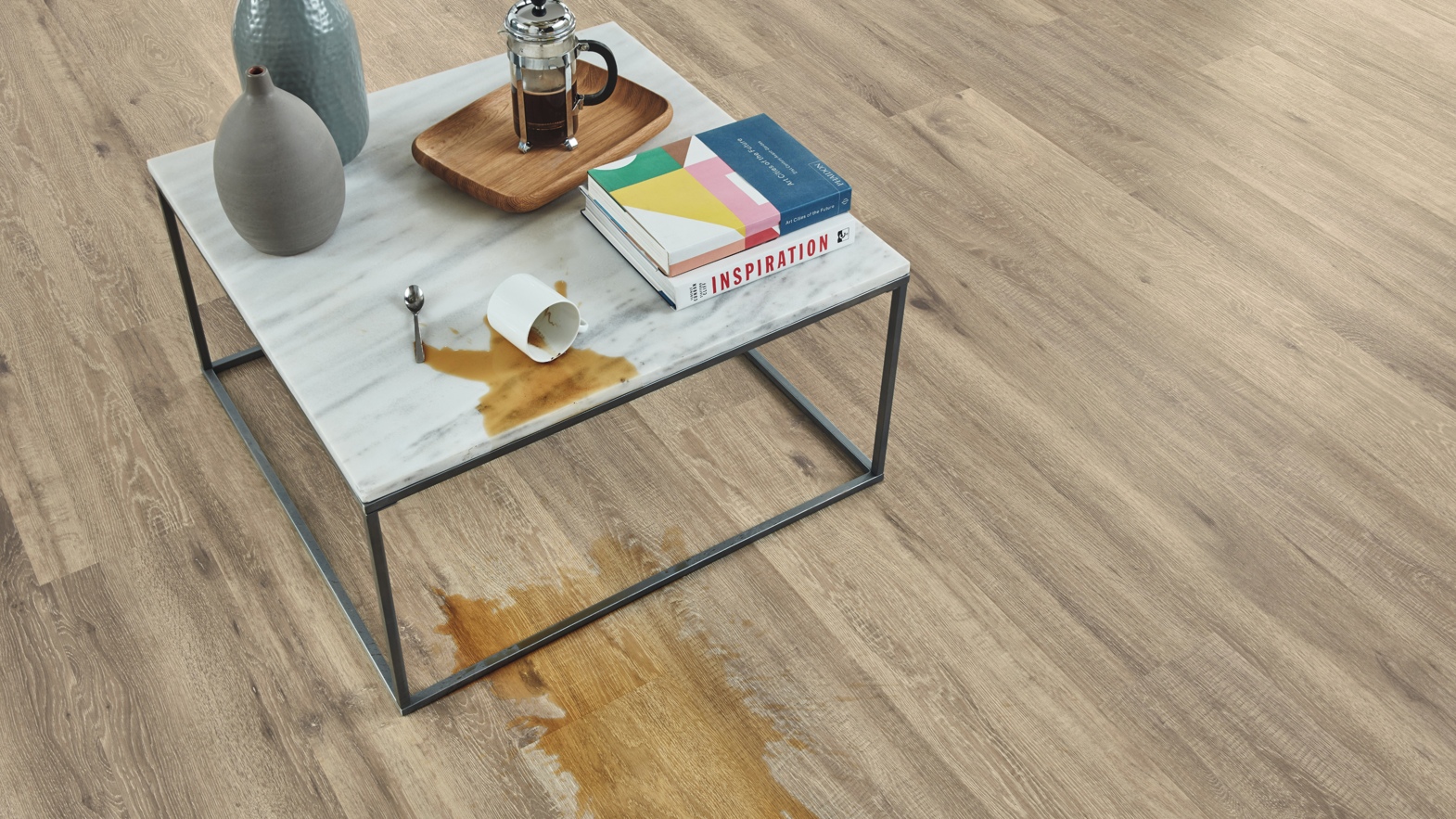 Karndean Designflooring baltic limed oak lvt wood flooring in a living room with coffee spelt on it