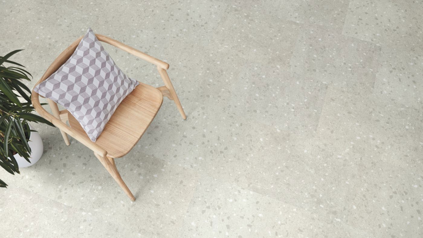 stone style luxury vinyl with a chair on it