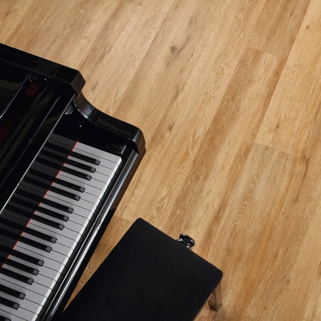 Baltic limed oak golden brown LVT flooring laid next to a piano