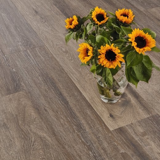 Baltic Mistral Oak grey LVT flooring laid straight with some flowers on top