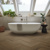 Duxbury Acacia dark brown herringbone LVT flooring laid in a bathroom